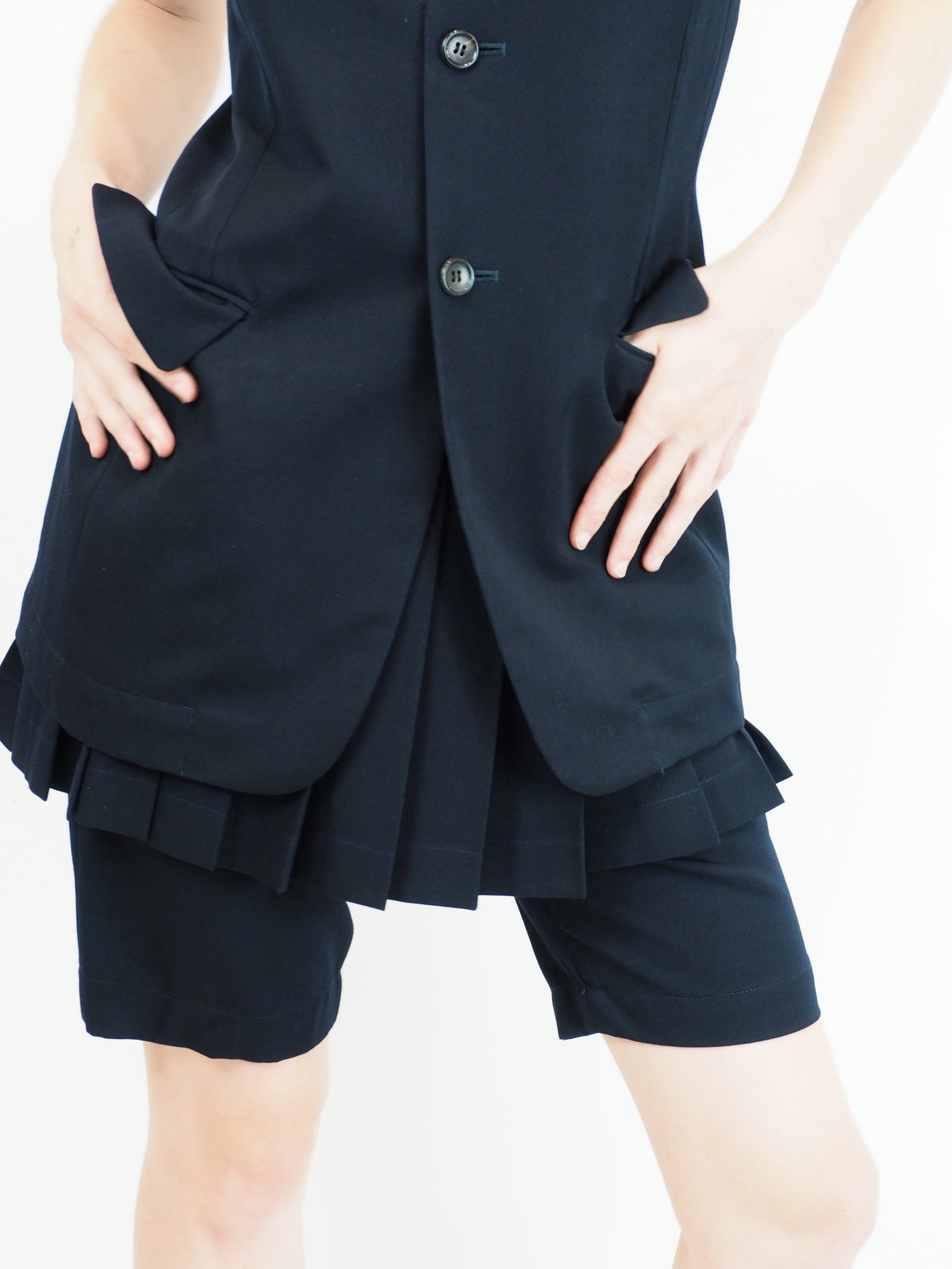 A vintage comme des garçons cold-shoulder blazer with matching navy shorts