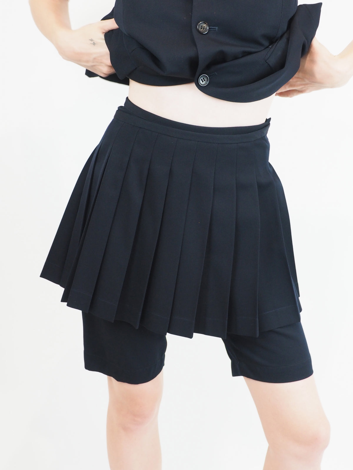 A vintage comme des garçons cold-shoulder blazer with matching navy shorts