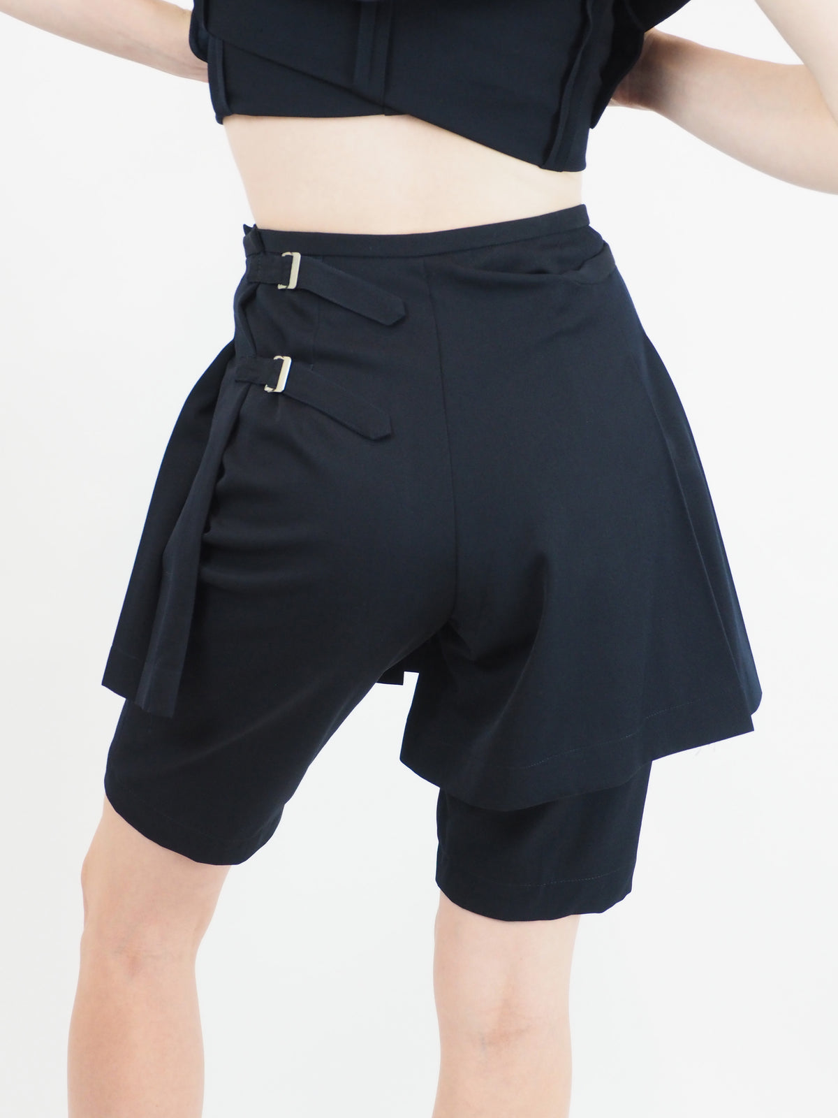 A vintage comme des garçons cold-shoulder blazer with matching navy shorts