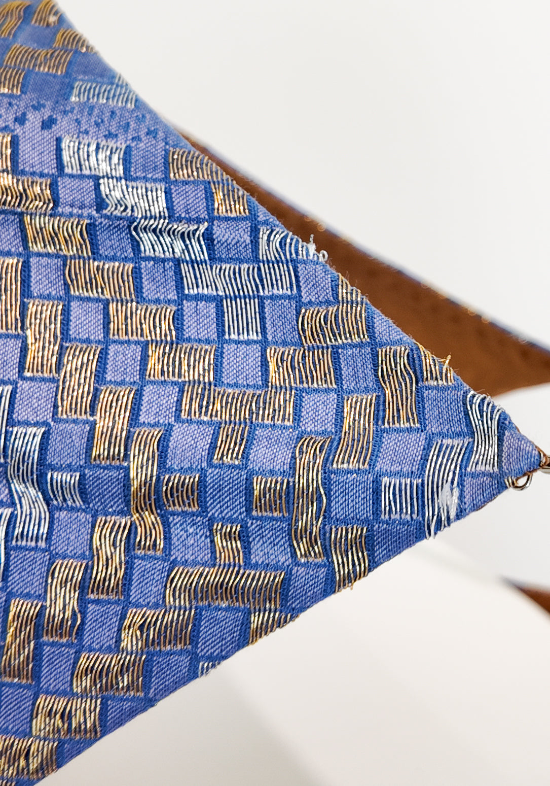 Blue fabric with gold pattern on a white background