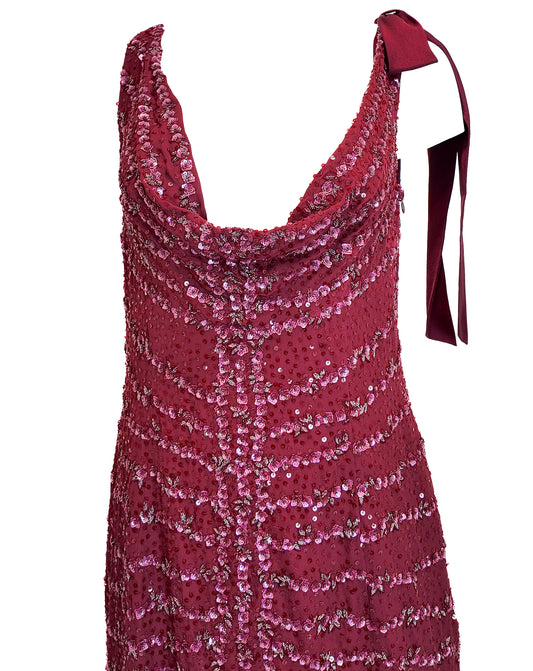 Red sequin dress with a bow detail on a white background