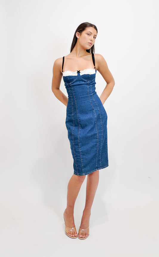 Woman wearing a D&G 2000s blue denim dress with white top on a white background