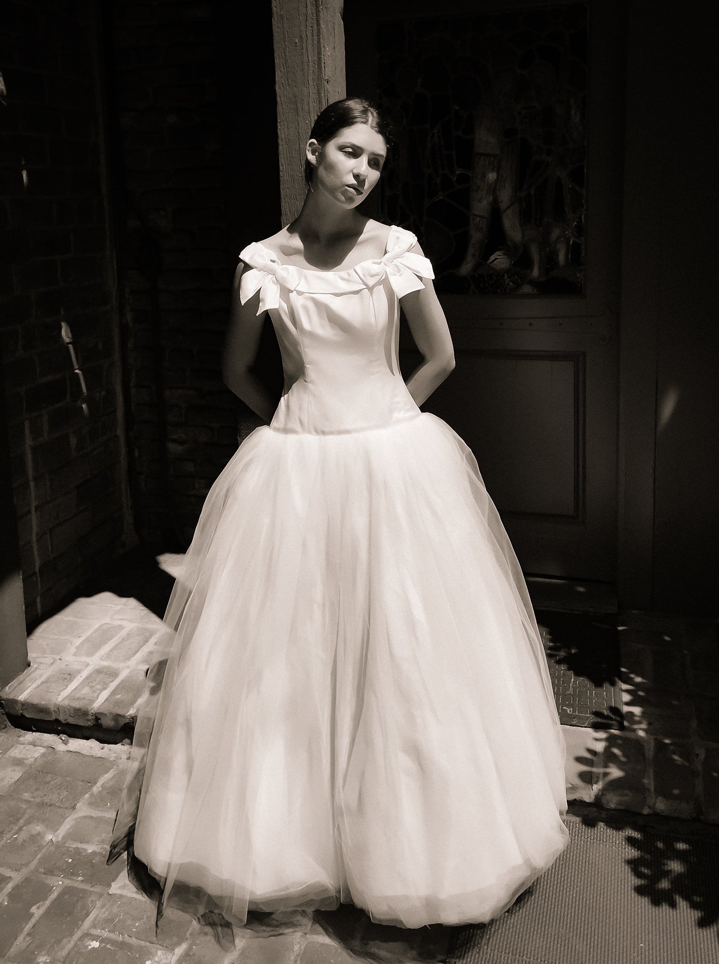 Woman in a Bob Evans for Neiman Marcus 1997 white wedding dress standing outdoors.