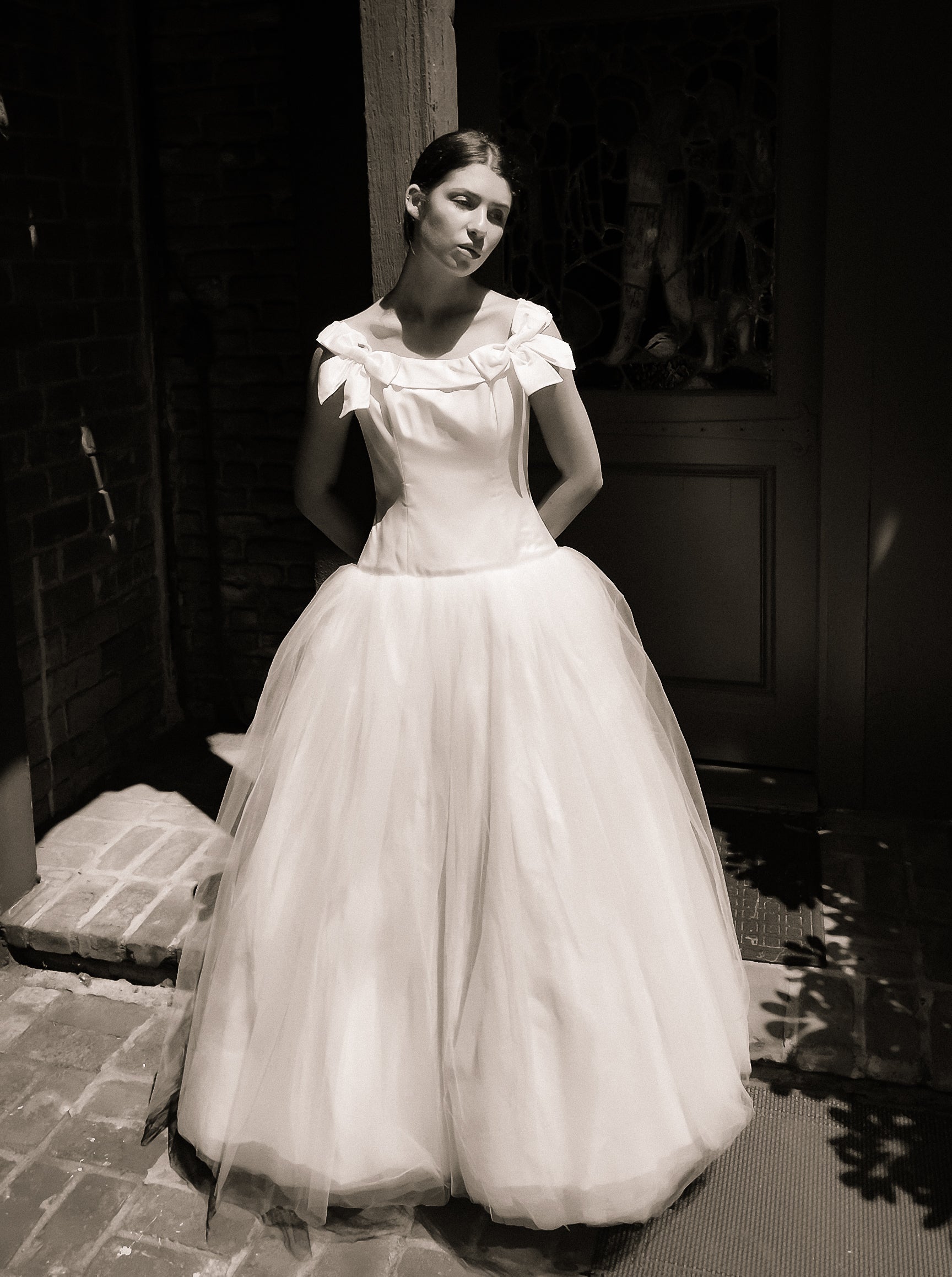Woman in a Bob Evans for Neiman Marcus 1997 white wedding dress standing outdoors.