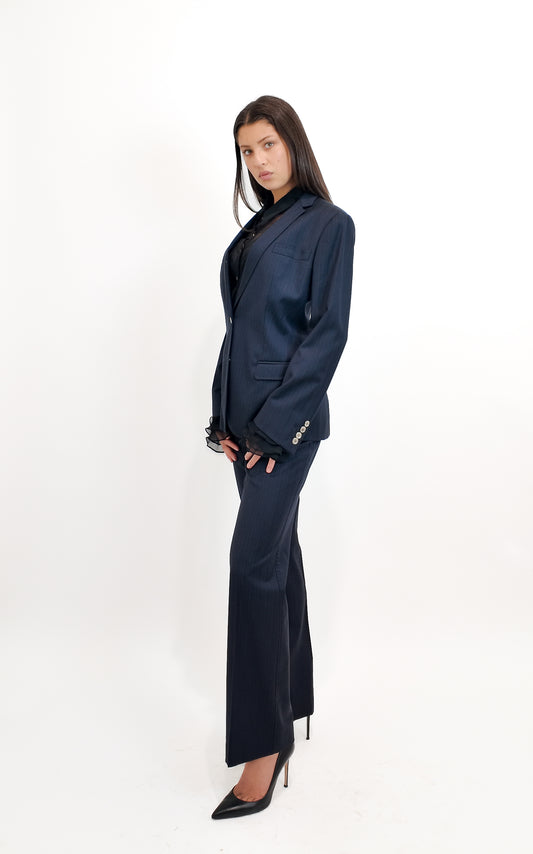 Woman wearing a navy blue suit on a white background