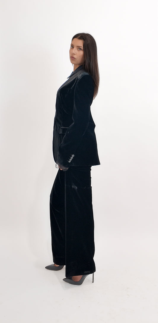 Person wearing a black velvet suit on a white background