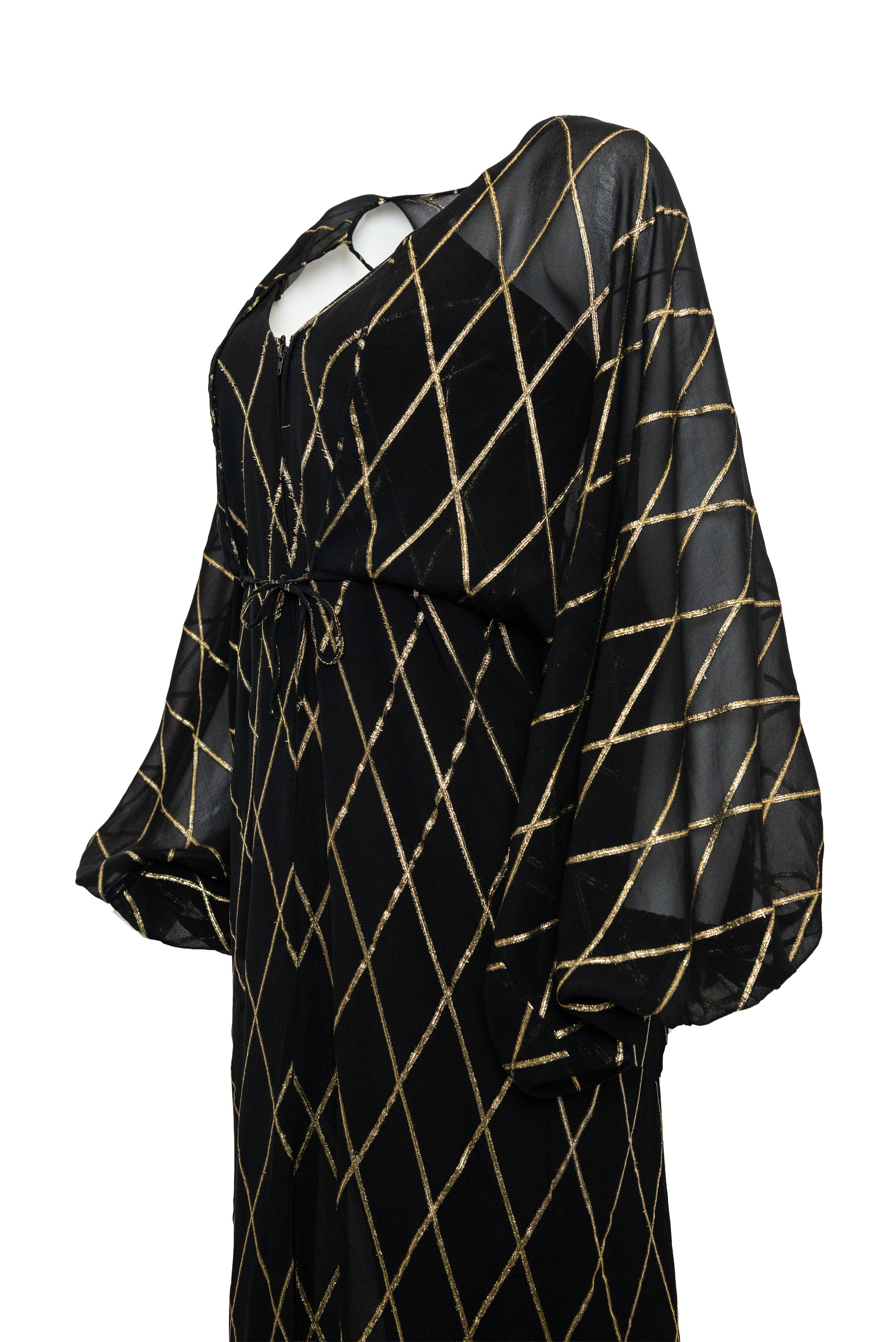 Black dress with gold geometric pattern on a white background
