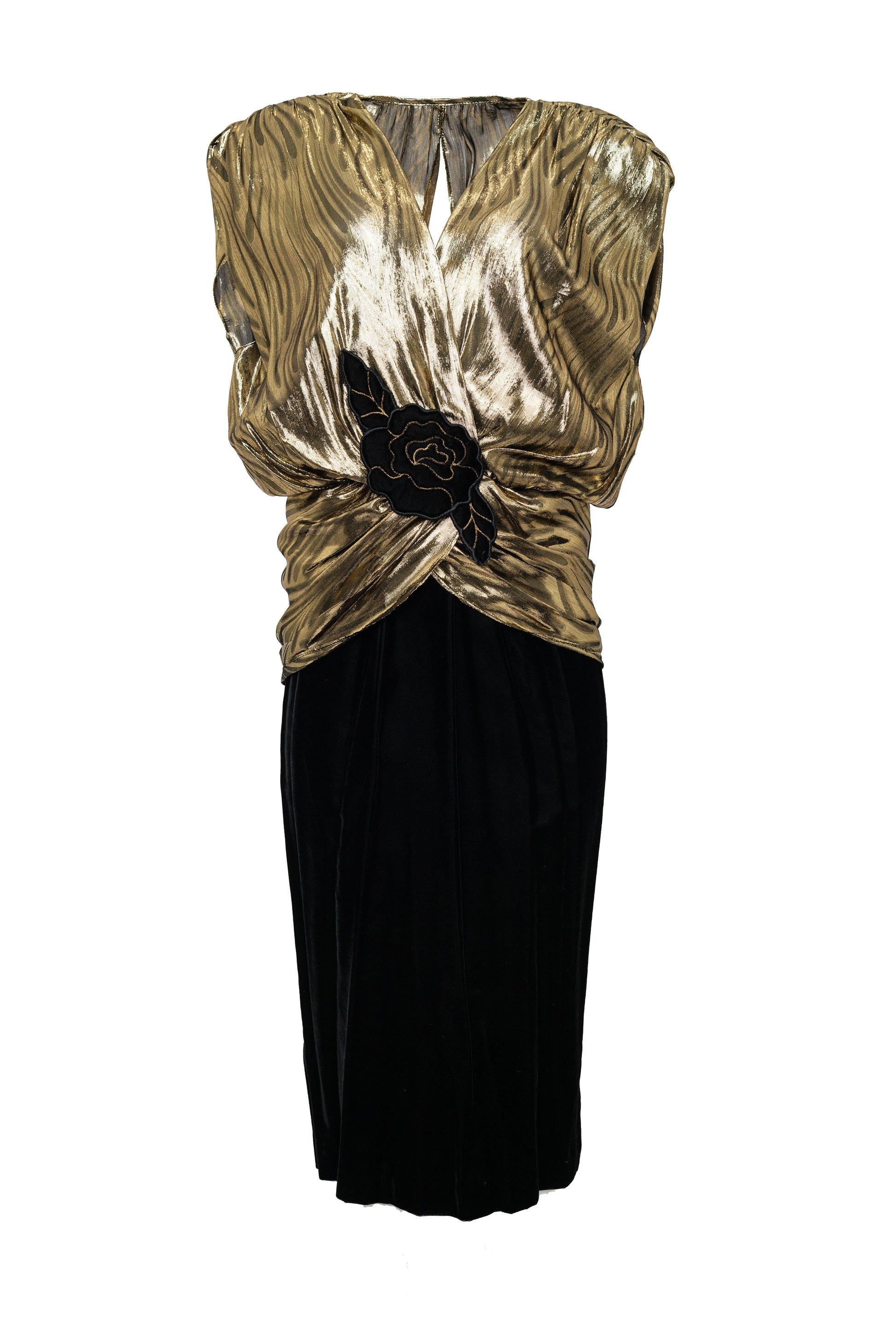 Gold and black evening gown with floral embellishments on a white background
