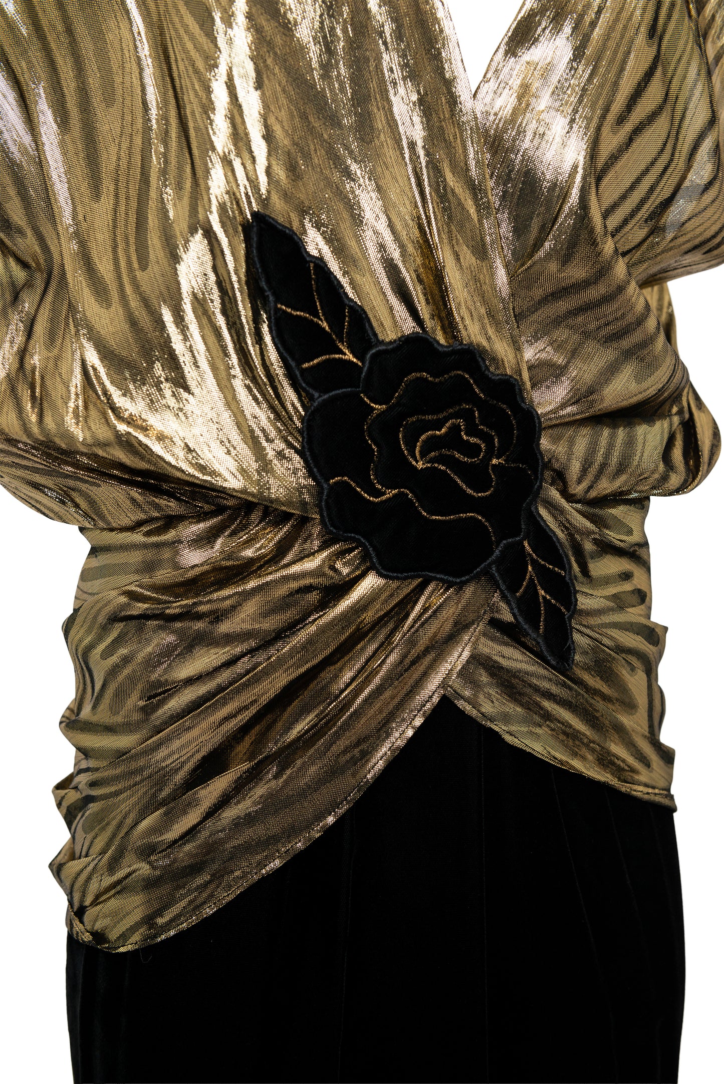 Gold textured top with a black floral detail on a white background