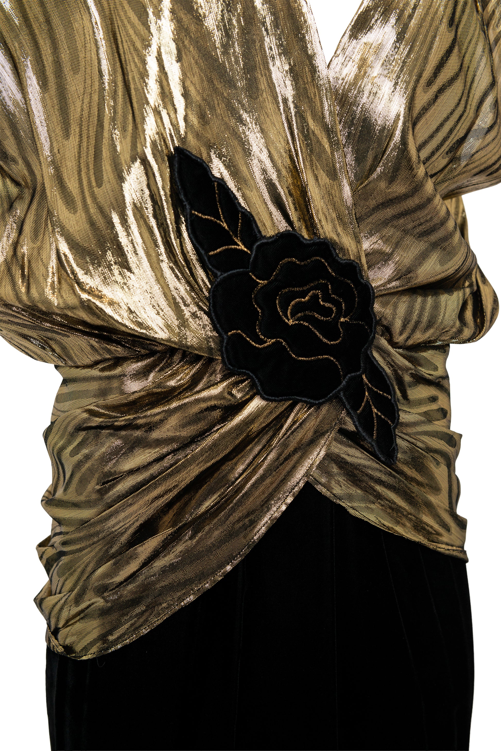 Gold textured top with a black floral detail on a white background