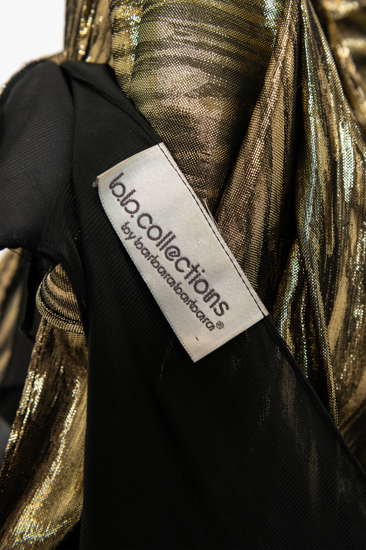Gold and black fabric with a label reading bb collections