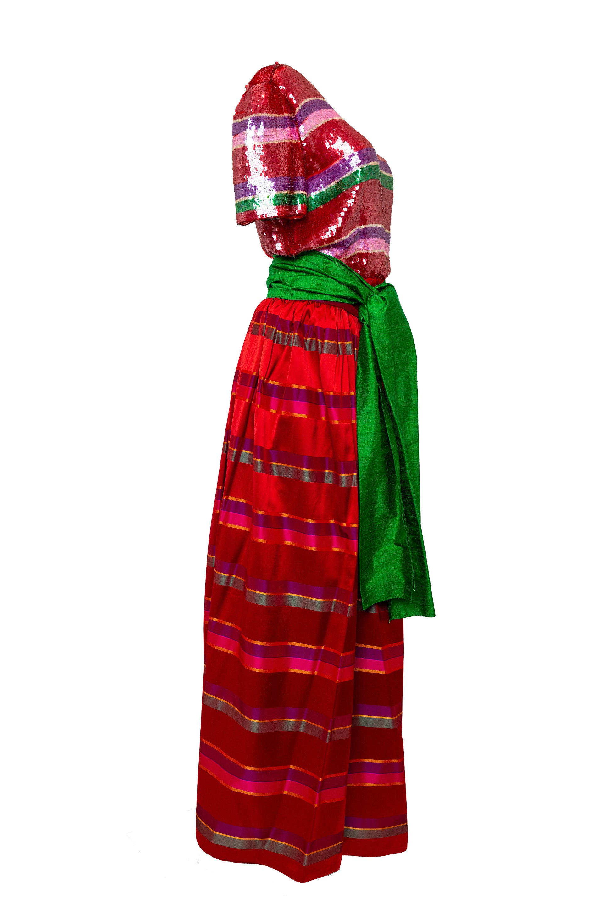 Red and green traditional outfit with a headscarf on a white background