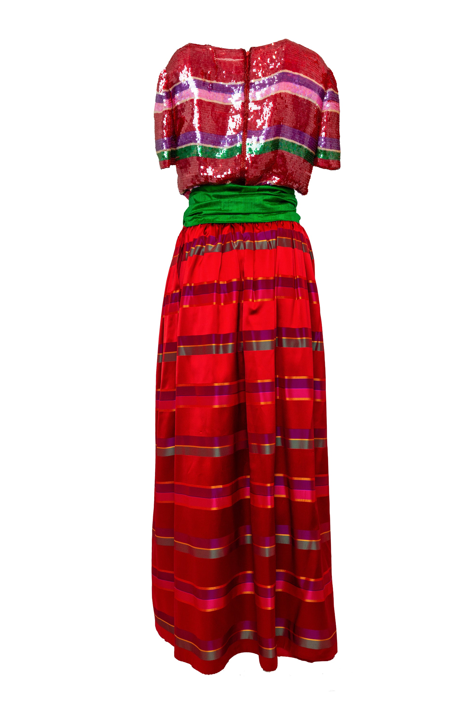 Red and green traditional outfit with a sequined top on a white background