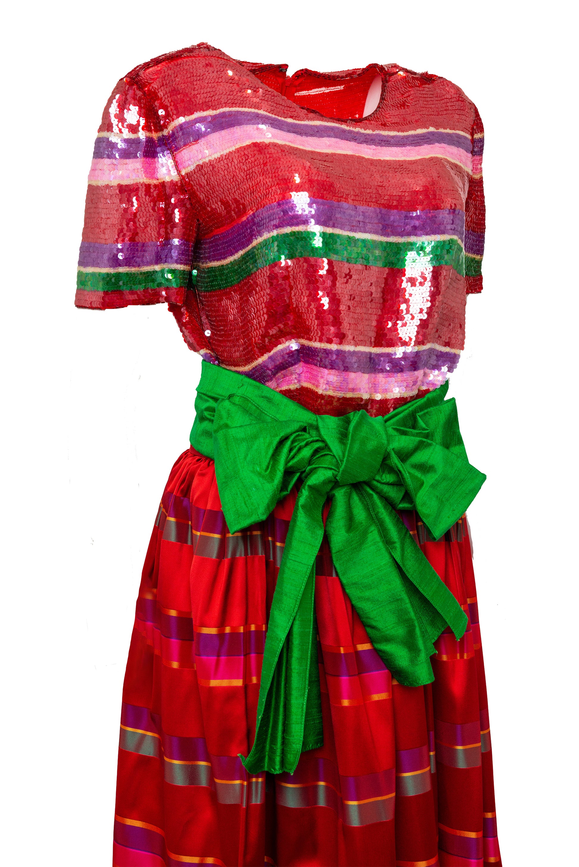 Red dress with colorful stripes and a green bow on a white background