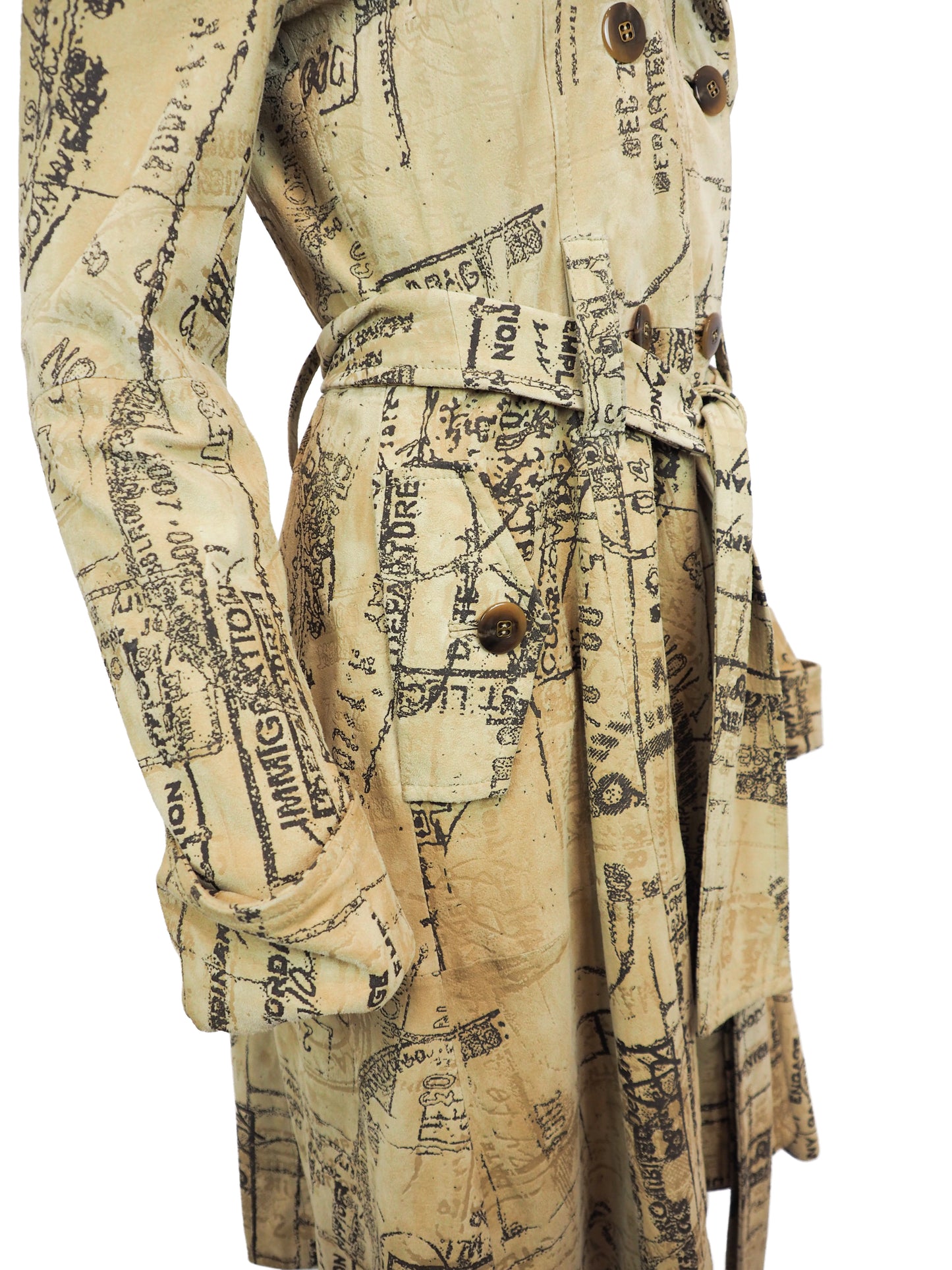 A Diane Von Furstenberg beige trench coat with an all-over black vintage map and script print, featuring a double-breasted design with brown buttons and a matching waist tie, shown against a plain white background.