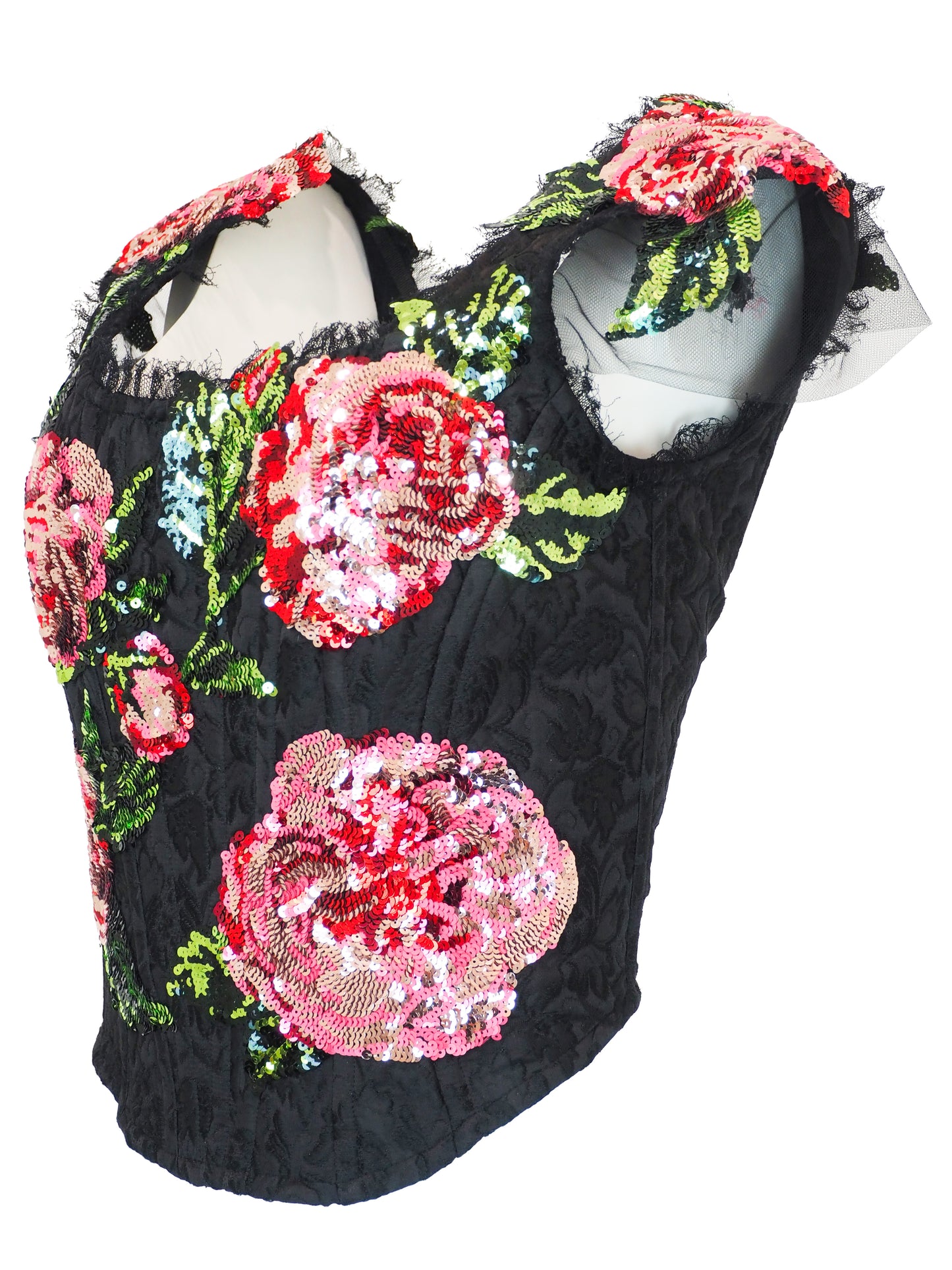 A Vintage dolce and Gabbana 2017 black sequined crop top featuring large pink and red floral sequin patterns with green sequin leaves, sheer ruffled cap sleeves, and a mesh  neckline.