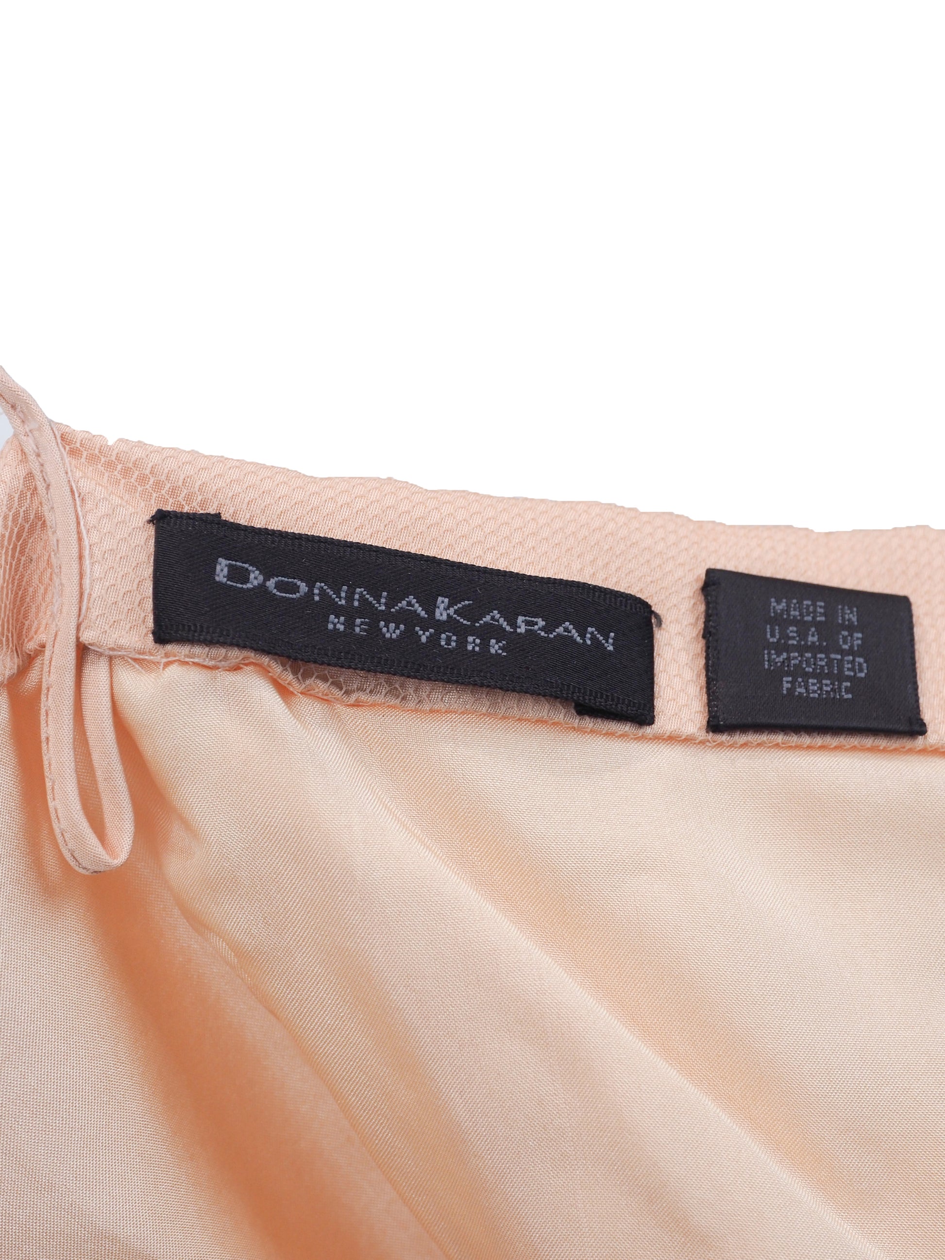A vintage Donna Karan pink colored sheer mesh camisole top with thin straps, embellished with scattered sequins and a feather hem