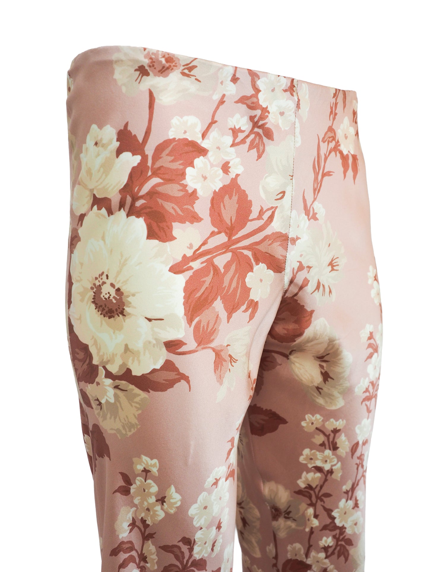 vintage Jane booke wide-leg trousers in a light pink satin-like fabric with an all-over floral print in cream, rust, and muted red, shown against a plain white background.