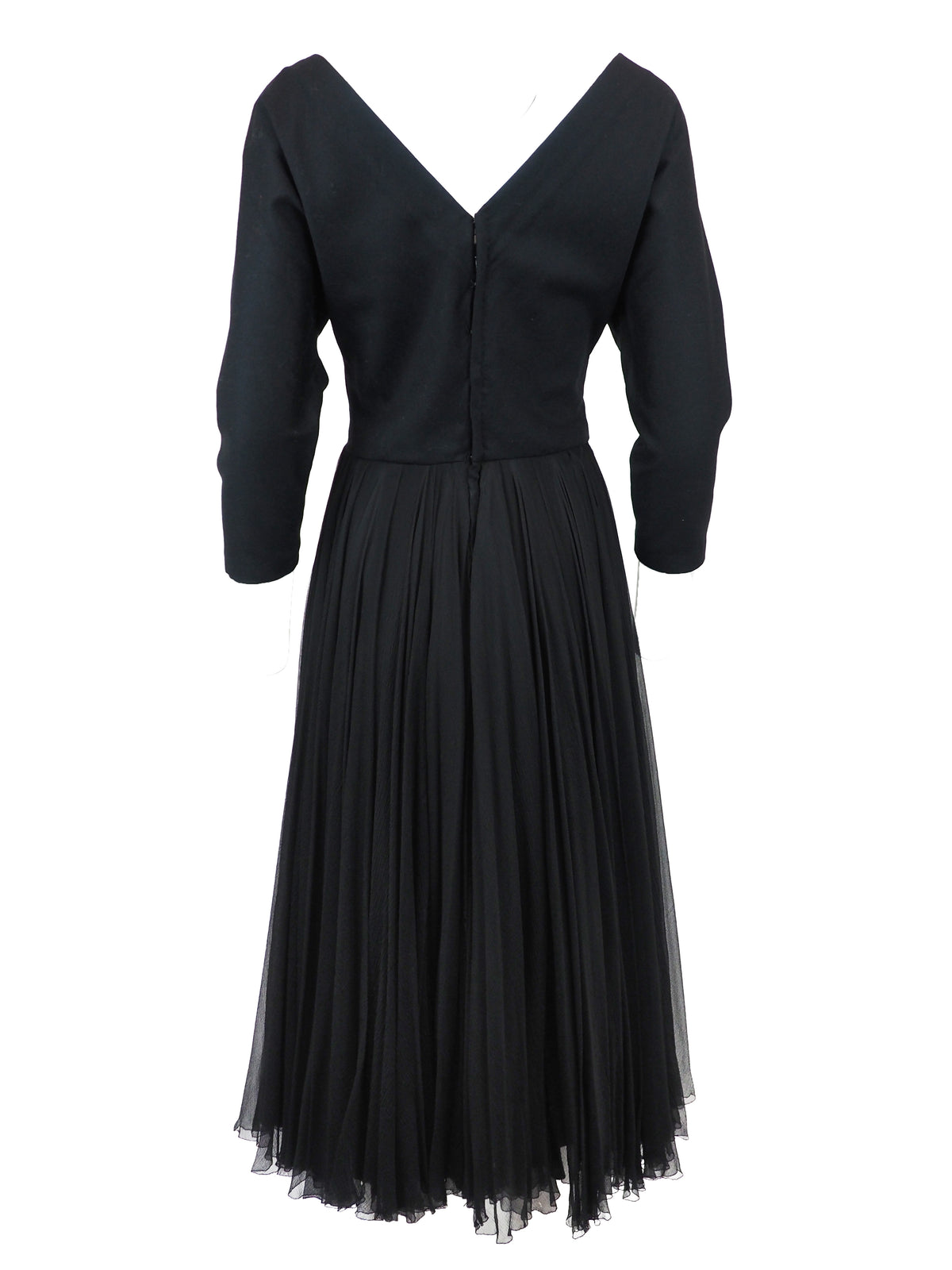 A vintage galanos black long-sleeve midi dress with a V-neckline, three-quarter button placket, and a pleated chiffon skirt