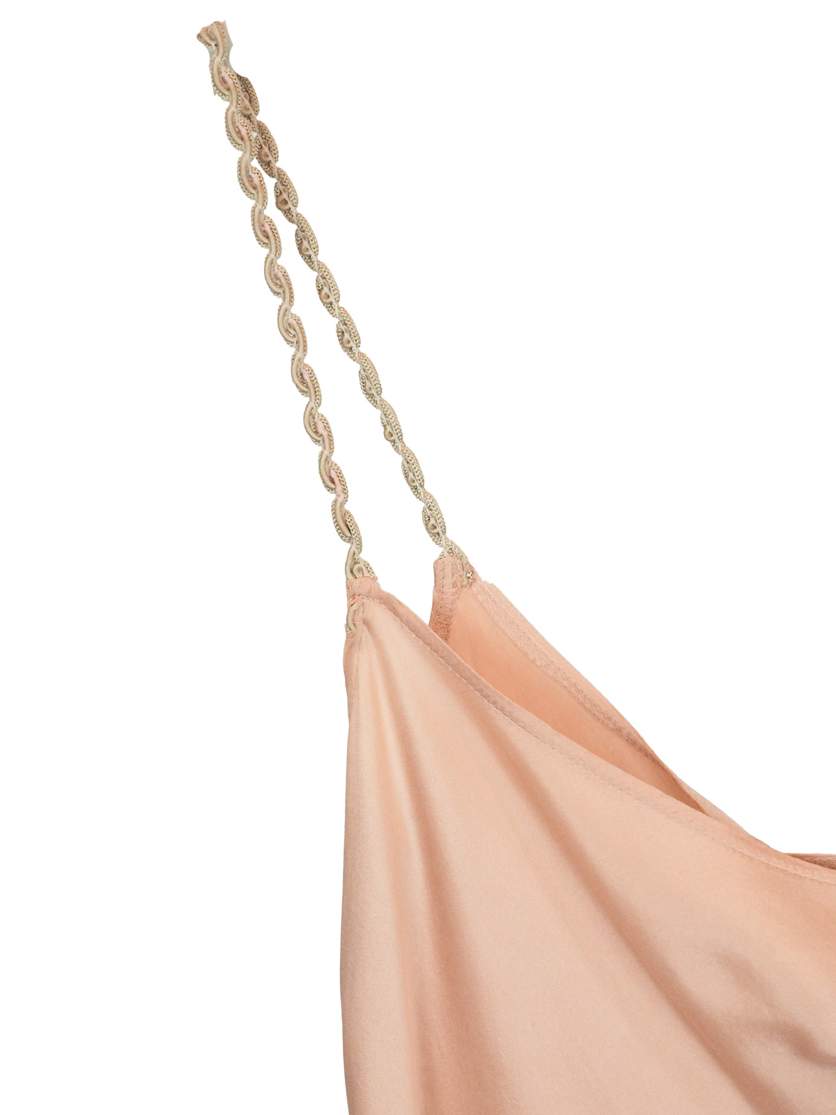 A light peach satin slip dress with thin braided straps