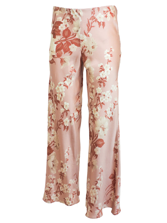 vintage Jane booke wide-leg trousers in a light pink satin-like fabric with an all-over floral print in cream, rust, and muted red, shown against a plain white background.