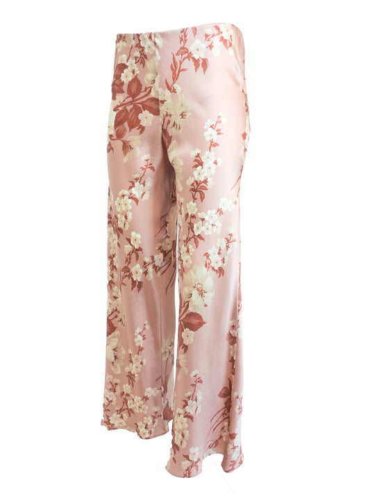 vintage Jane booke wide-leg trousers in a light pink satin-like fabric with an all-over floral print in cream, rust, and muted red, shown against a plain white background.