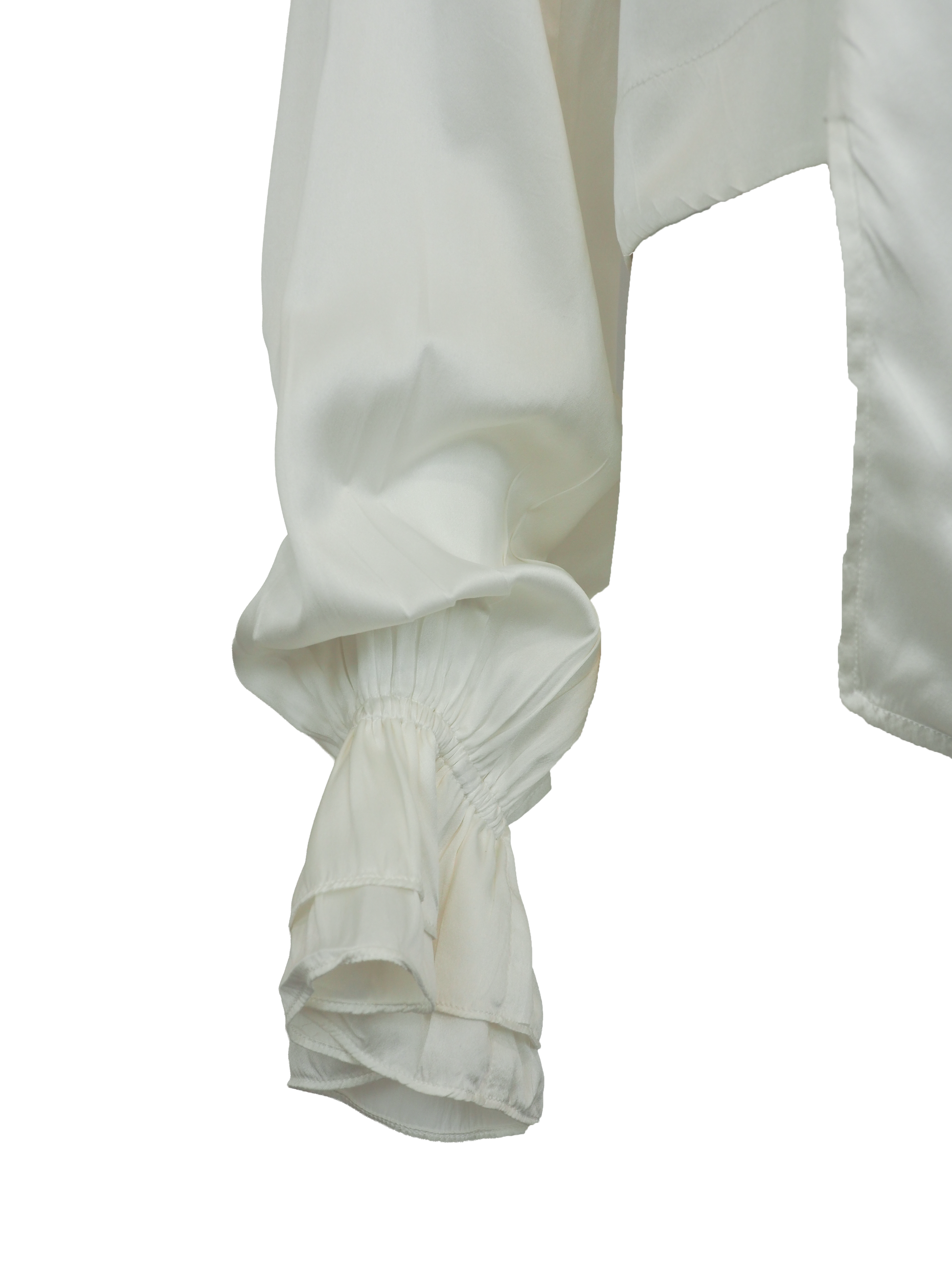 vintage designer Jane booke. An off-white silk blouse with a pointed collar, buttoned front, and dramatic ruffled cuffs, shown against a plain white background.
