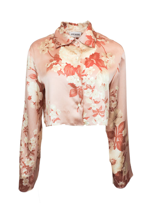 Jane Booke vintage designer long-sleeve satin button-up blouse with a floral print in shades of pink, red, and cream, featuring a pointed collar and cropped hem.
