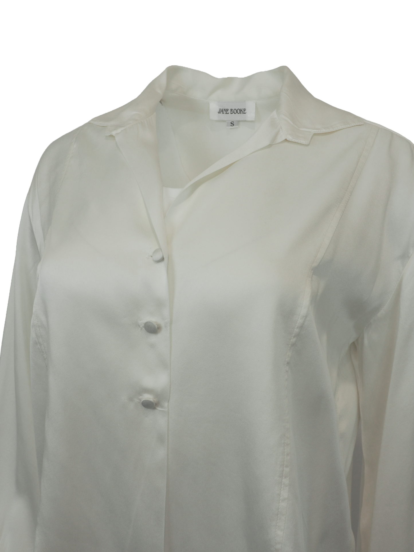 vintage designer Jane booke. An off-white silk blouse with a pointed collar, buttoned front, and dramatic ruffled cuffs, shown against a plain white background.