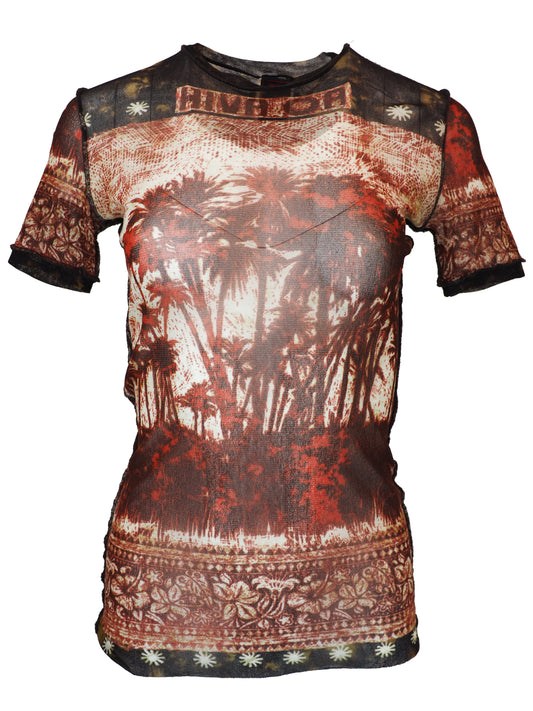 A vintage jean Paul gaultier short-sleeve t-shirt with a distressed, vintage-style graphic print featuring a tropical palm tree scene in shades of red, brown, and beige, with tribal-style patterns on the shoulders and hem.