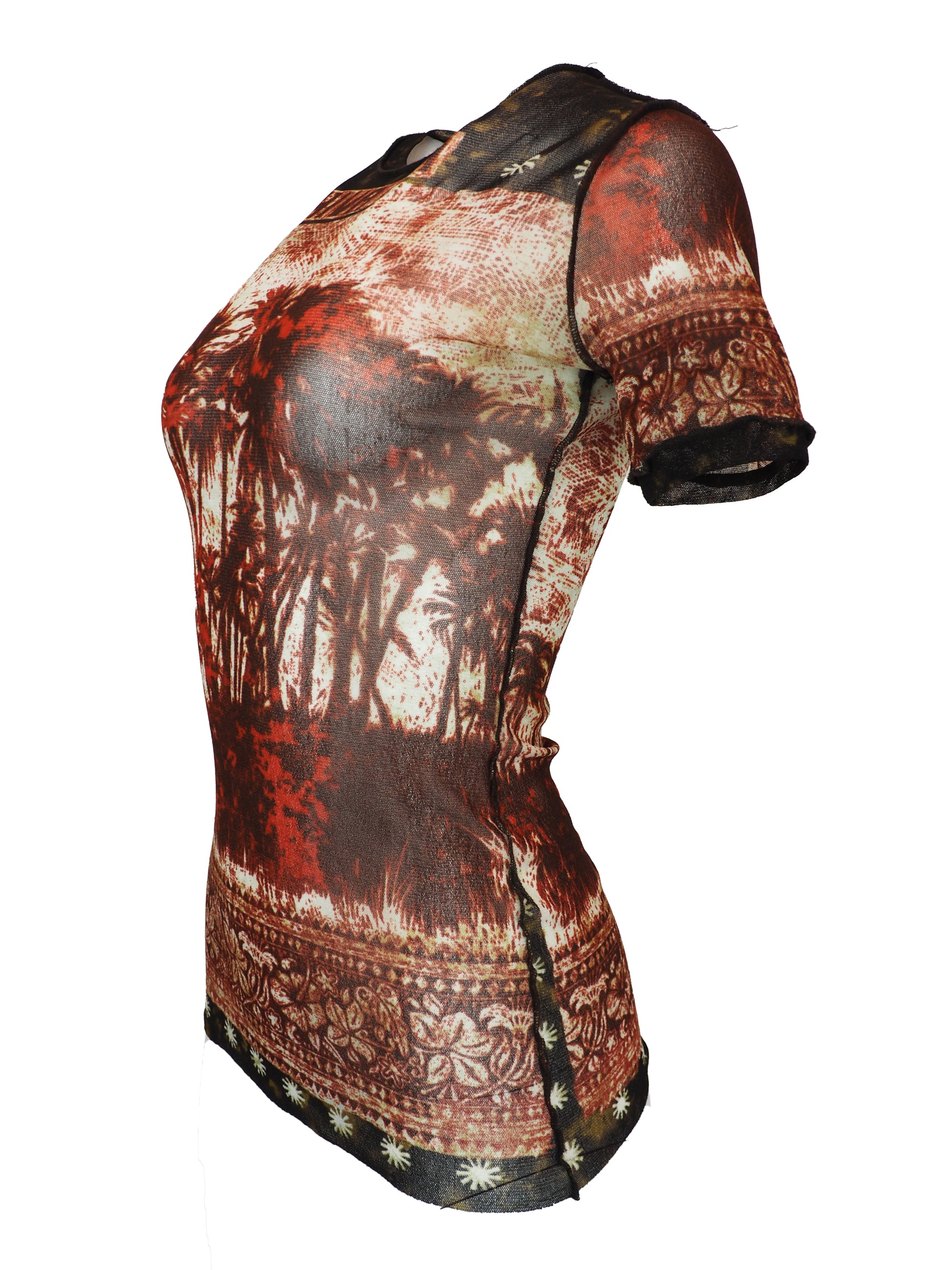 A vintage jean Paul gaultier short-sleeve t-shirt with a distressed, vintage-style graphic print featuring a tropical palm tree scene in shades of red, brown, and beige, with tribal-style patterns on the shoulders and hem.
