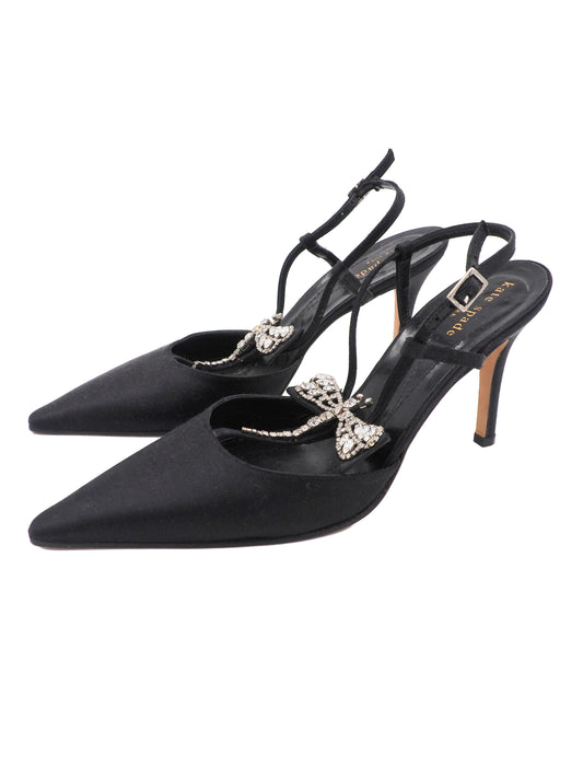 A pair of vintage Kate spade black pointed-toe slingback heels with delicate ankle straps, embellished with a jeweled dragonfly detail on the instep and a small gold buckle.