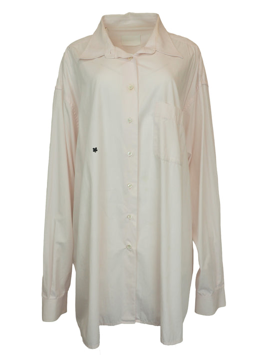 A vintage Maison Martin margiela 2001 pale blush pink oversized button-down shirt dress with a pointed collar, long sleeves, and a small black embroidered clover on the left chest