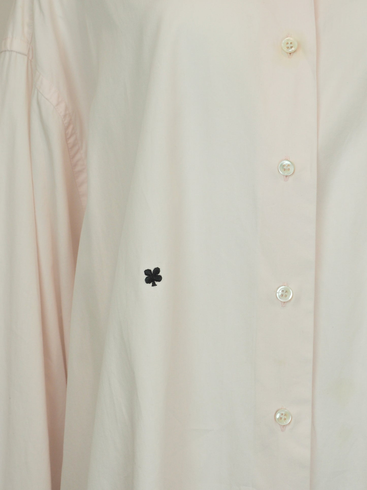 A vintage Maison Martin margiela 2001 pale blush pink oversized button-down shirt dress with a pointed collar, long sleeves, and a small black embroidered clover on the left chest