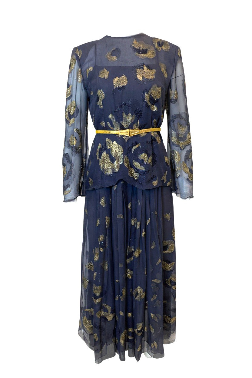 Lavender vintage dress with gold floral patterns and a belt on a white background