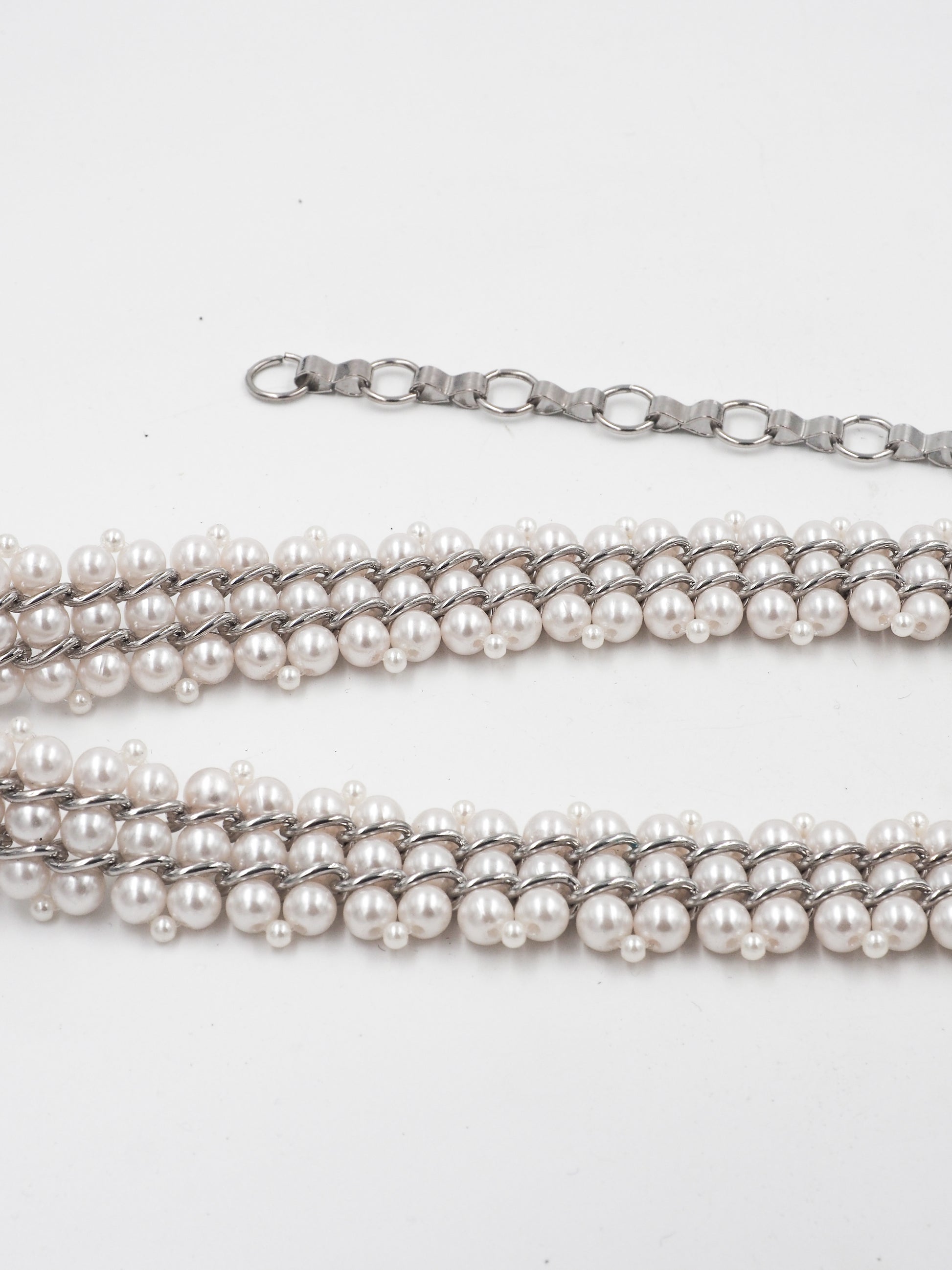 A vintage multi-strand pearl belt with a silver-tone chain extender clasp