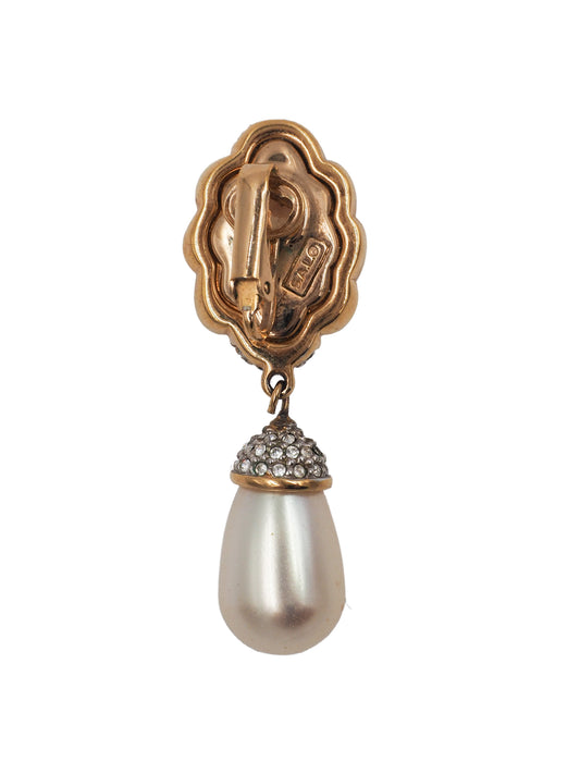 A pair of vintage gold and silver drop earrings featuring a twisted knot design paved with clear stones, with a teardrop-shaped white pearl hanging below each earring