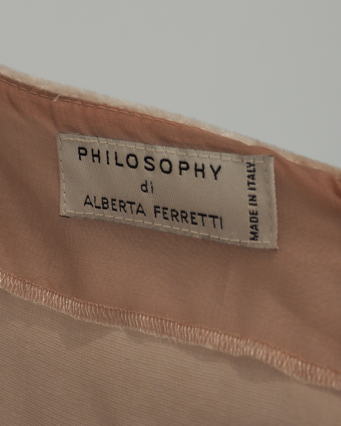 Alberta Ferreti light beige pink velvet cold-shoulder dress with three-quarter sleeves and a matching beige lace hem, shown against a plain white background.