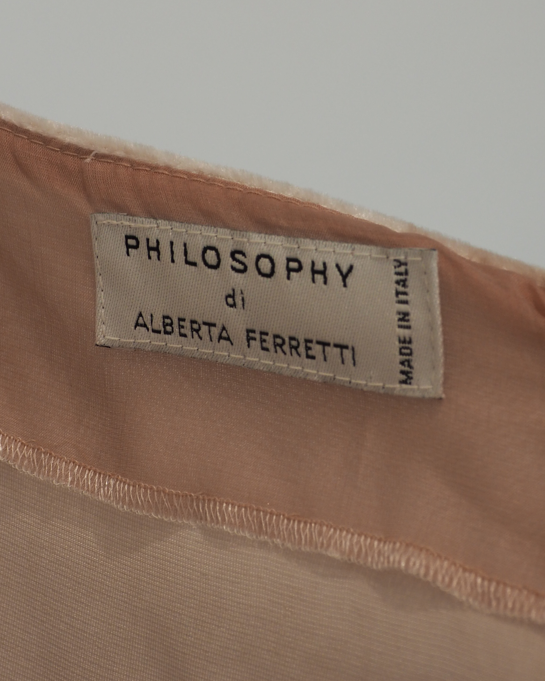 Alberta Ferreti light beige pink velvet cold-shoulder dress with three-quarter sleeves and a matching beige lace hem, shown against a plain white background.