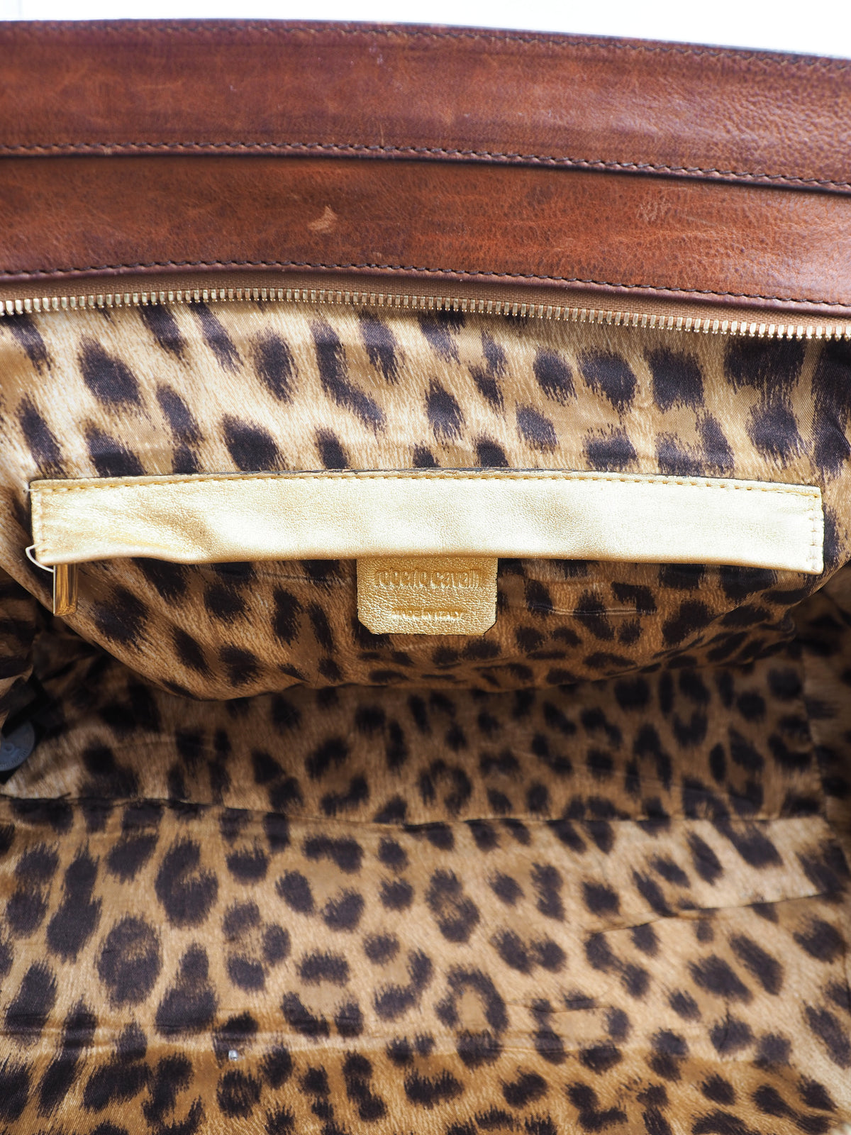 A vintage Roberto cavalli brown leather duffel-style handbag with rope handles and gold-tone hardware