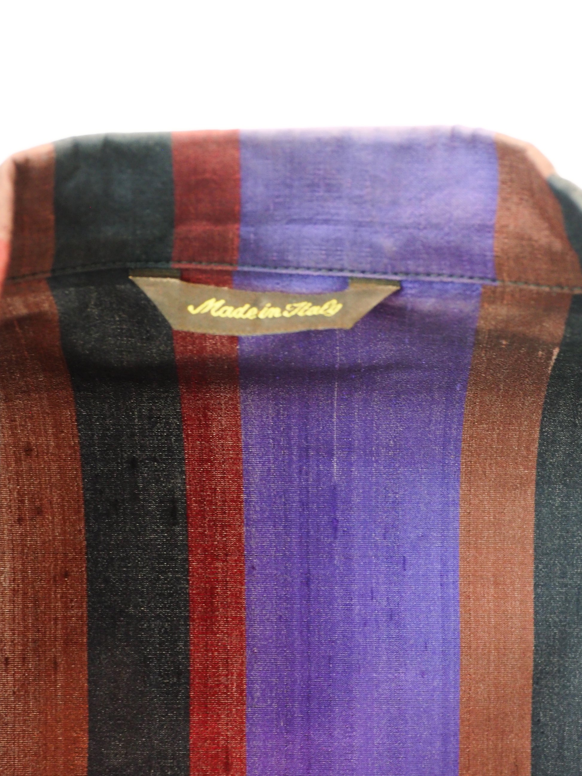 Romeo Gigli Vintage. A long-sleeve striped blazer with vertical stripes in purple, rust red, and black, featuring a three-button front closure and flap pockets.