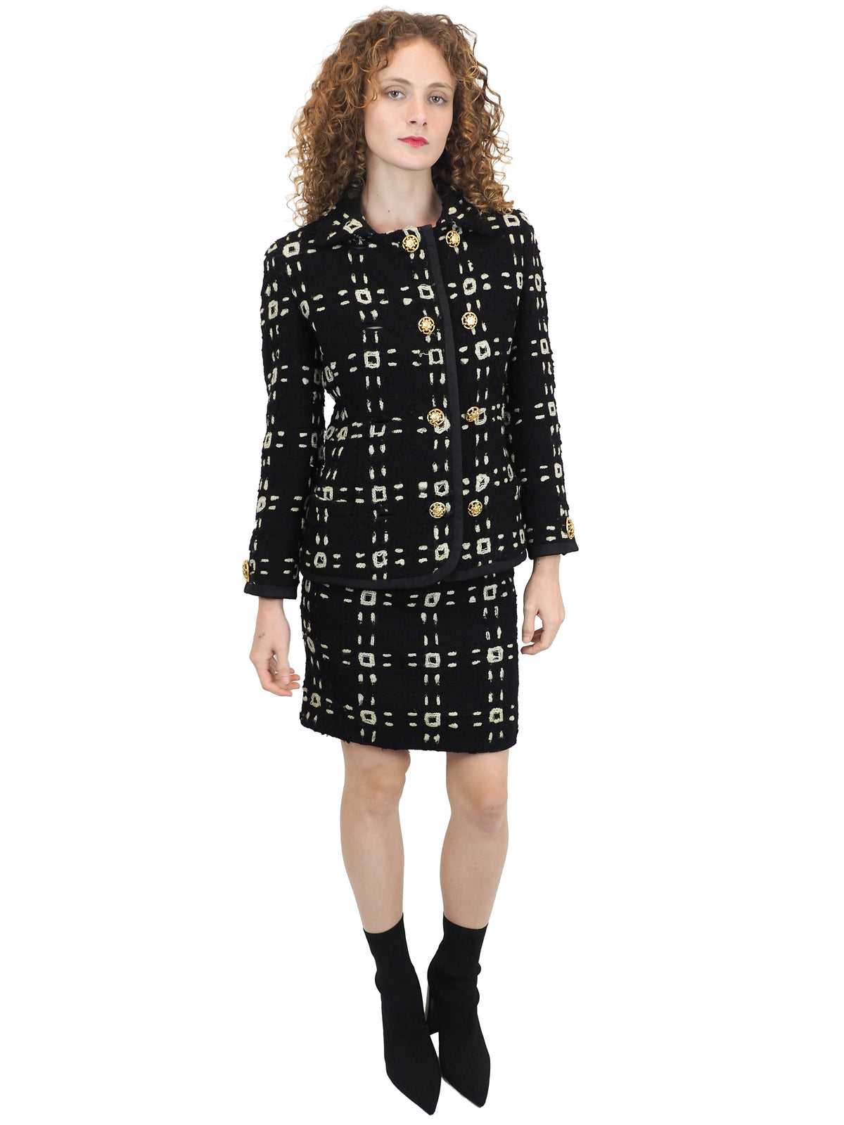 A vintage 1992 Gianni Versace black tweed jacket and matching mini skirt set with a beige geometric pattern and gold buttons