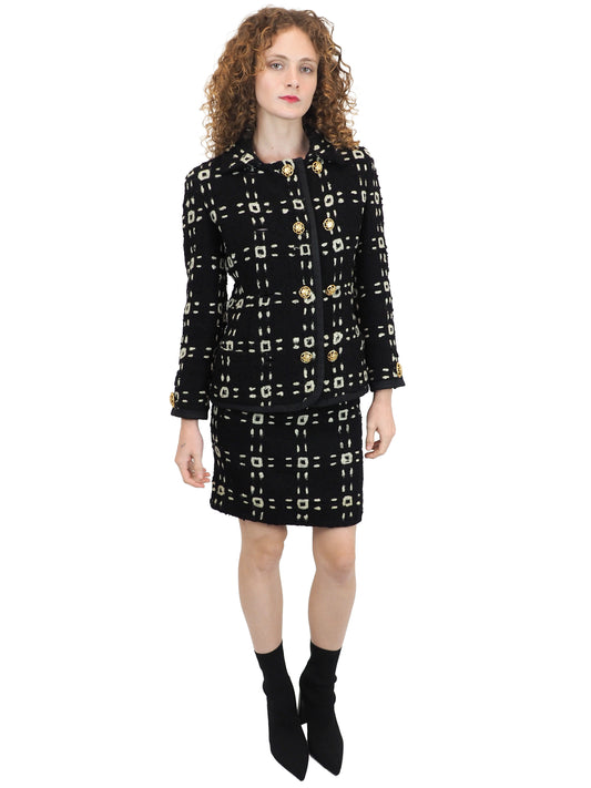 A vintage 1992 Gianni Versace black tweed jacket and matching mini skirt set with a beige geometric pattern and gold buttons