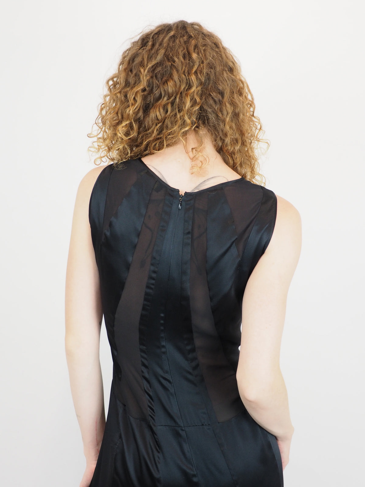 A vintage Versace Y2K 2000s sleeveless black maxi dress or gown with sheer mesh panels