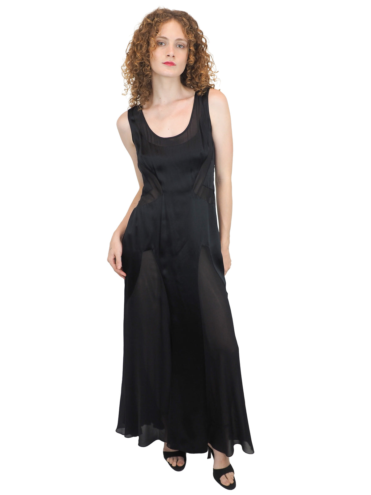 A vintage Versace Y2K 2000s sleeveless black maxi dress or gown with sheer mesh panels
