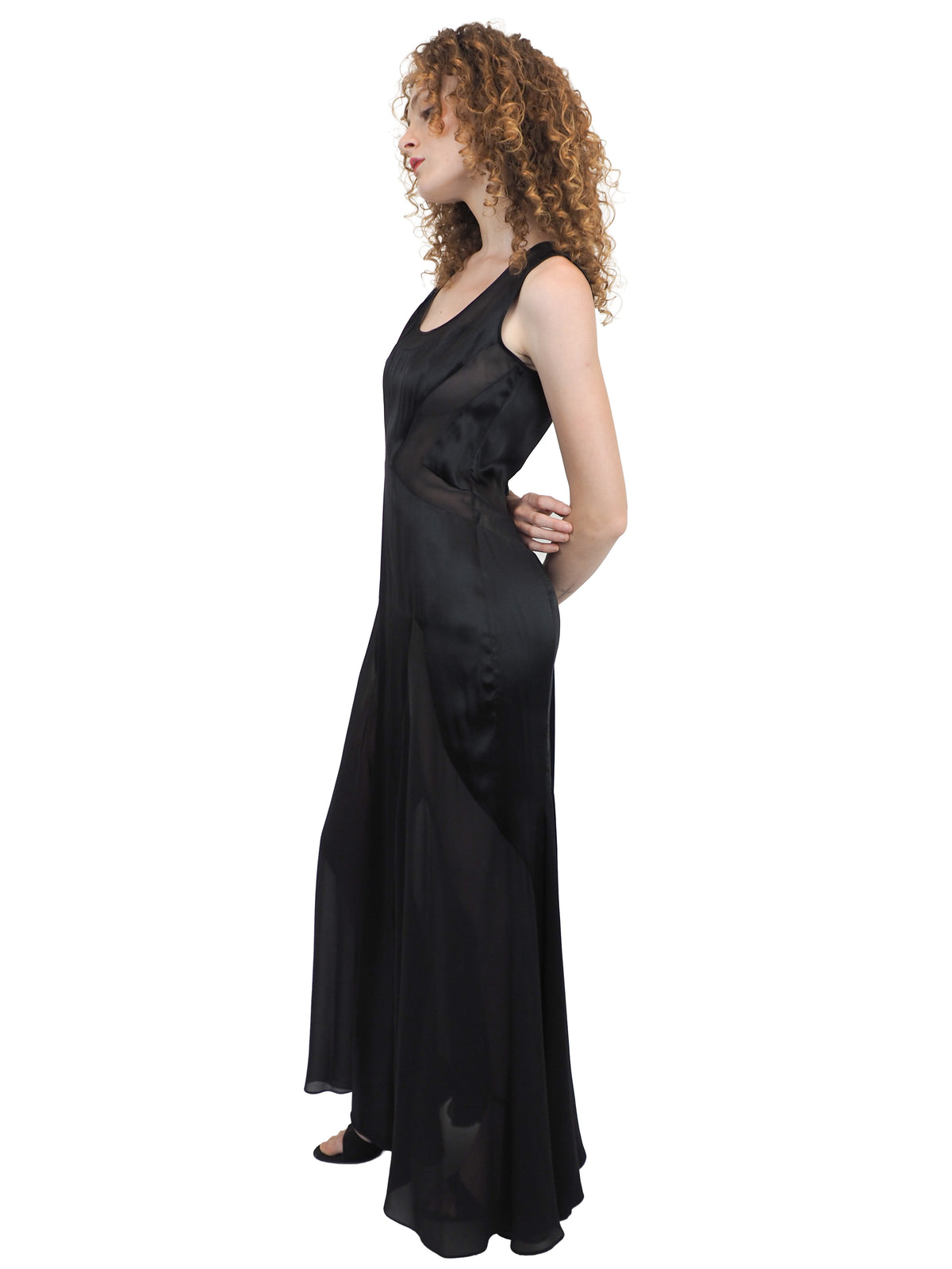 A vintage Versace Y2K 2000s sleeveless black maxi dress or gown with sheer mesh panels