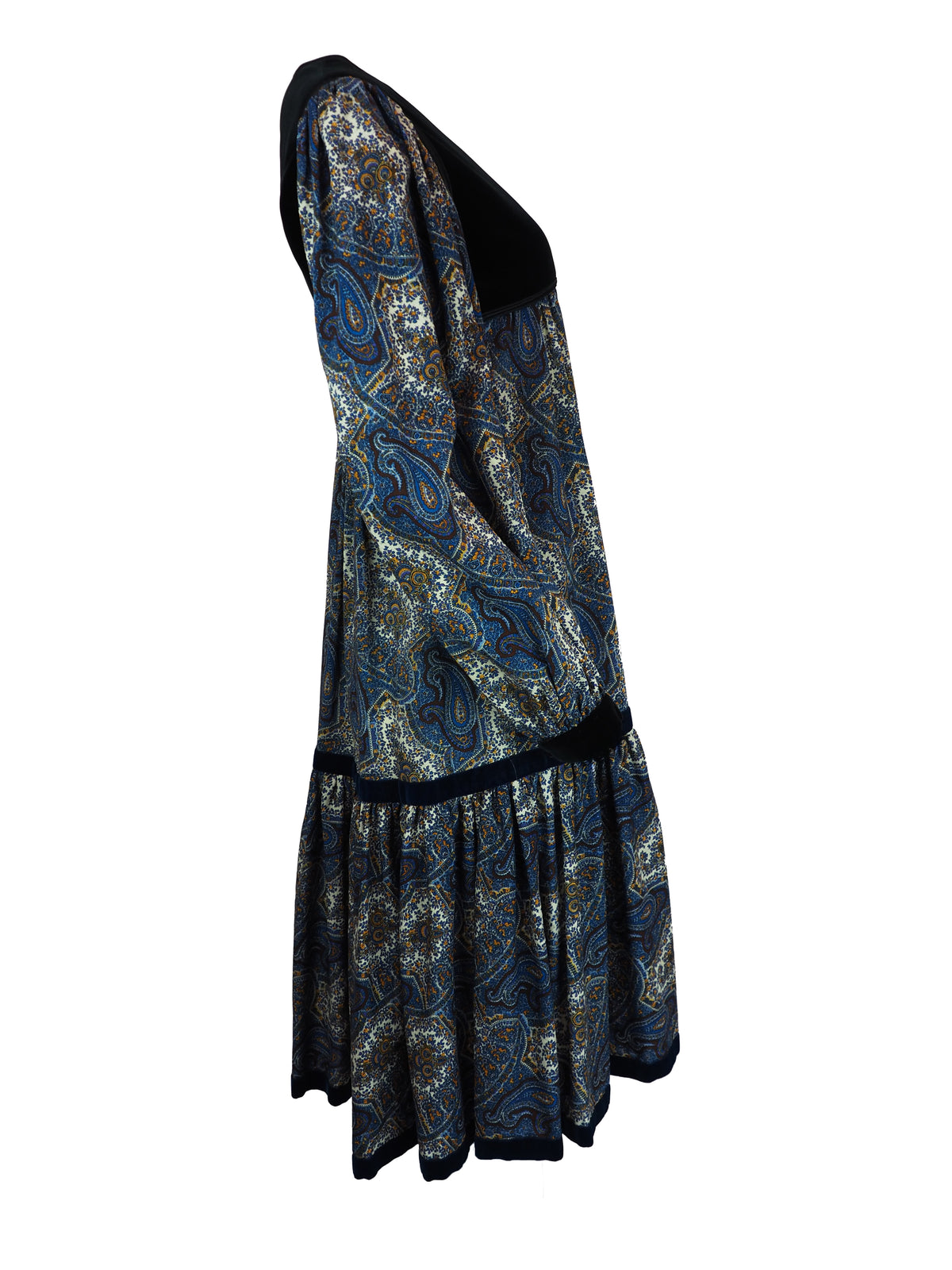 A 1976 Yves Saint Laurent Ballet Russes  long-sleeve midi dress with a black velvet yoke and cuffs, and a blue, gold, and white paisley patterned skirt