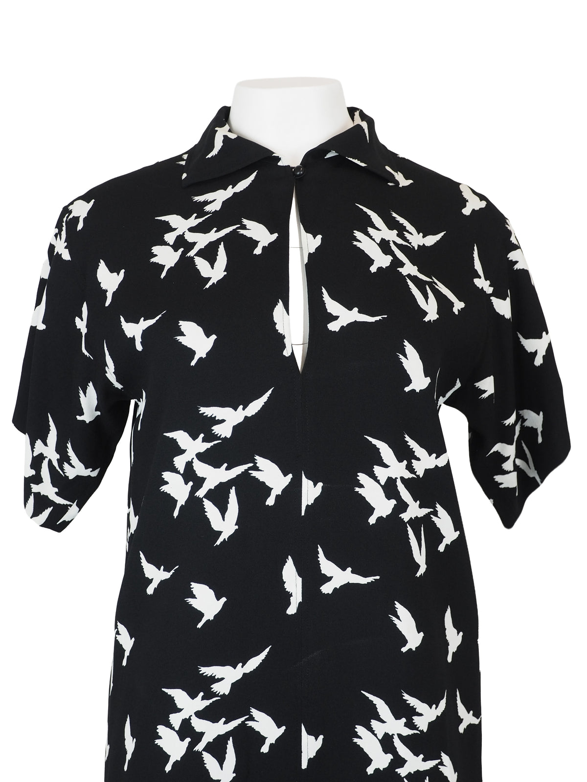 A vintage Yves Saint Laurent YSL 1970's black short-sleeve midi dress with a white bird pattern