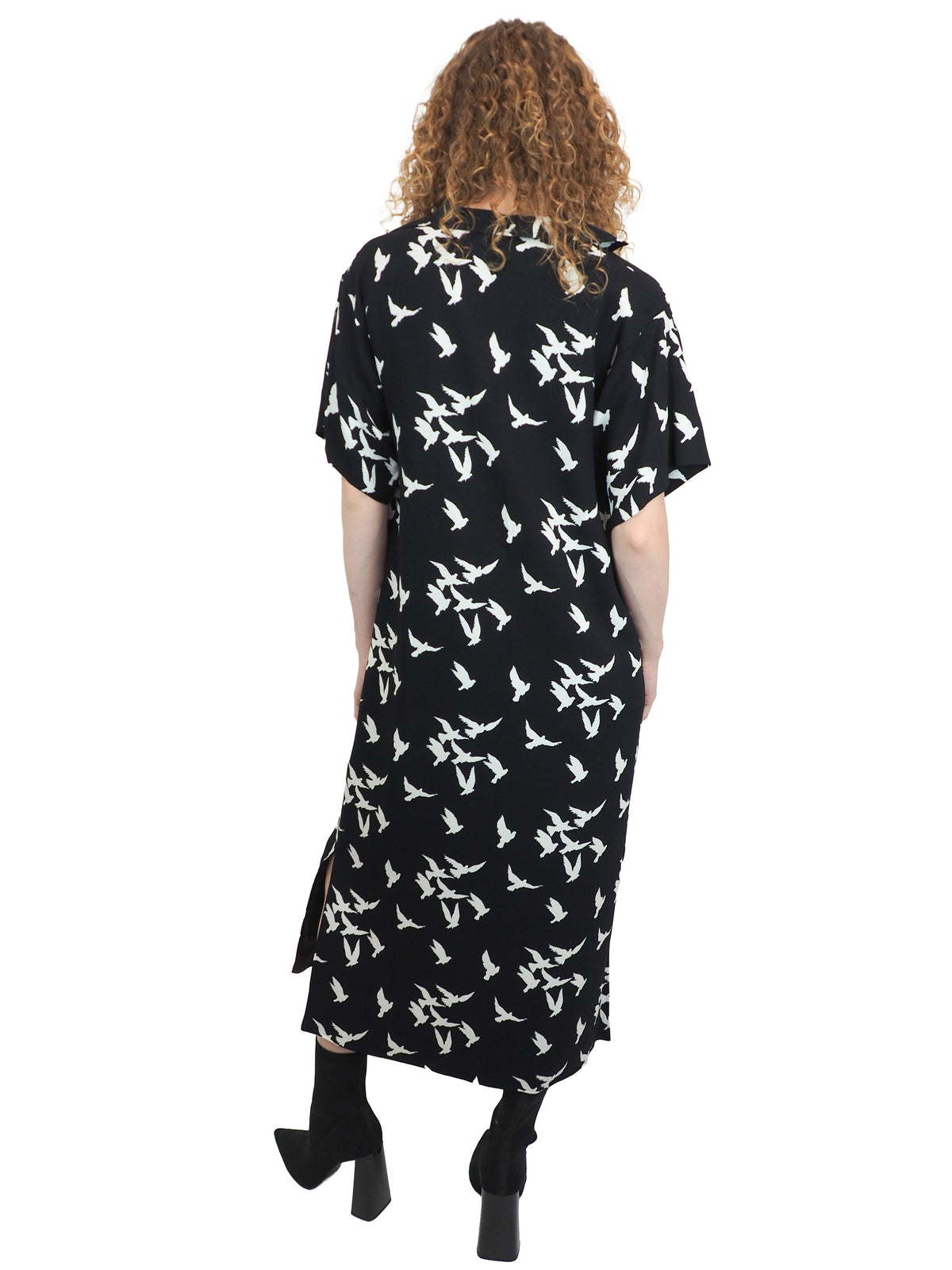 A vintage Yves Saint Laurent YSL 1970's black short-sleeve midi dress with a white bird pattern