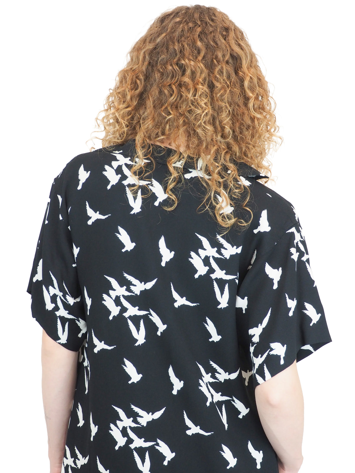 A vintage Yves Saint Laurent YSL 1970's black short-sleeve midi dress with a white bird pattern